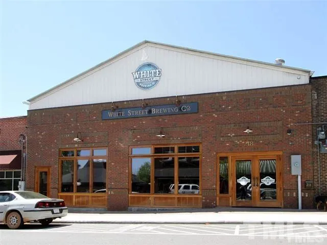 a view of a building with car parked