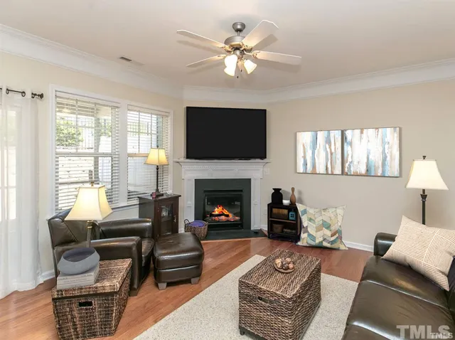 a living room with furniture a flat screen tv and a fireplace