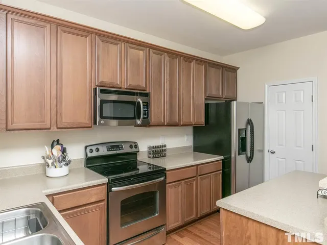 a kitchen with a sink a stove and refrigerator