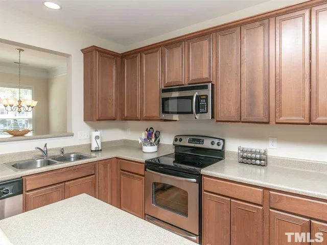 a kitchen with sink a microwave and cabinets