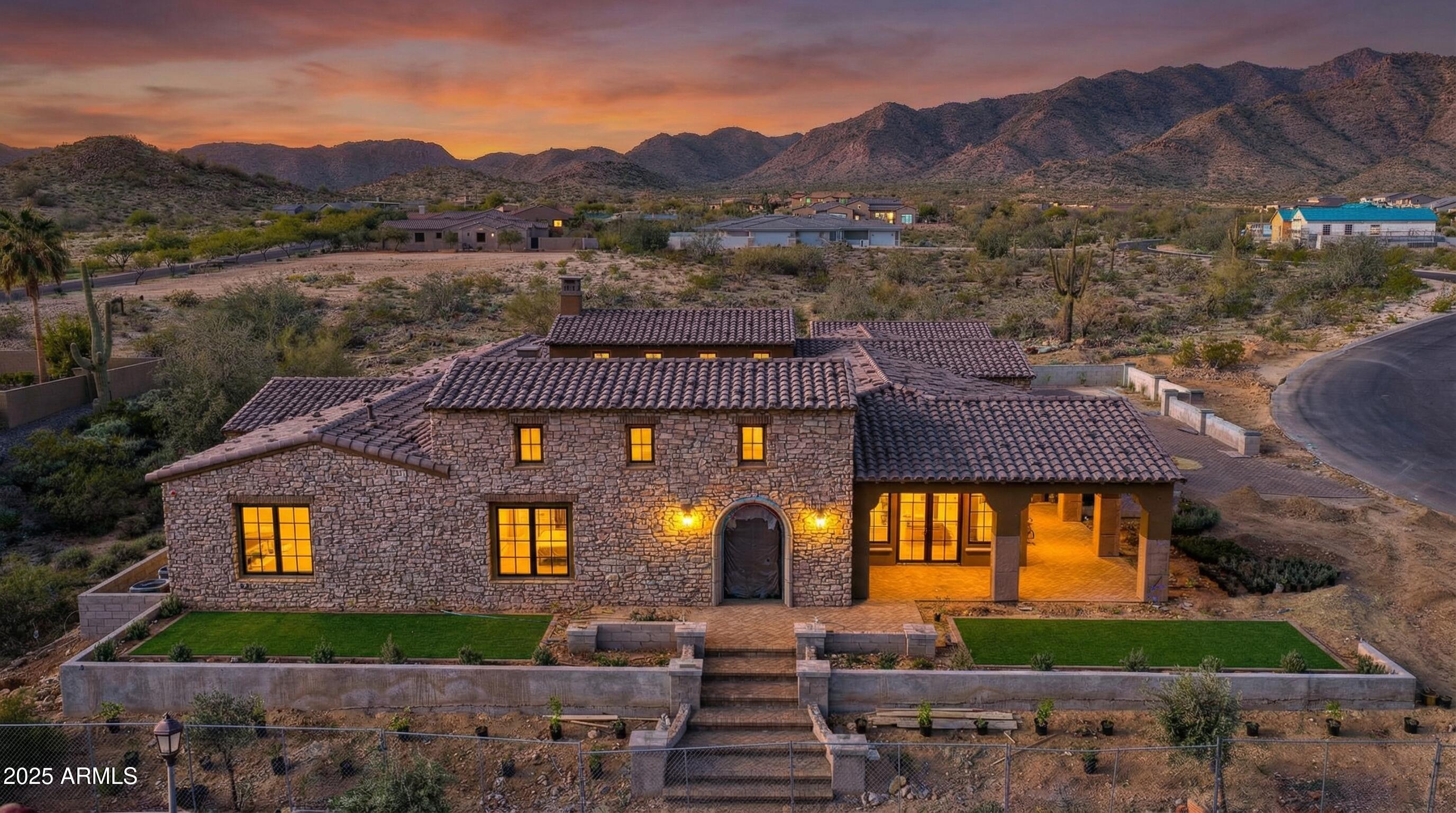 4572 North Regent Street Buckeye, AZ 85396 - Photo 2 of 25 a front view of a house with a yard and a large tree