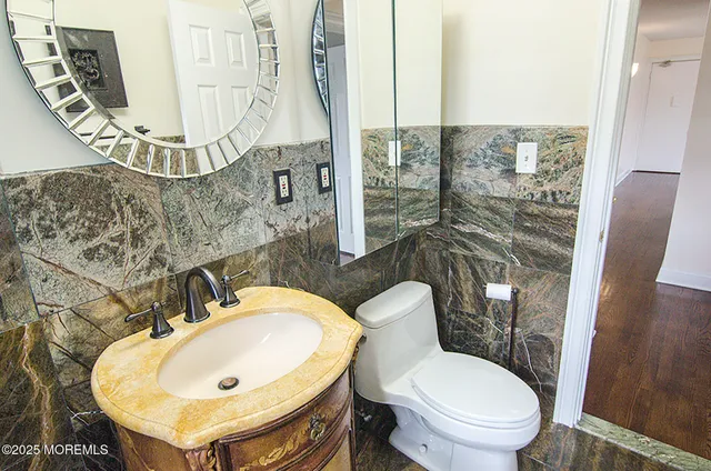 a bathroom with a toilet sink and mirror