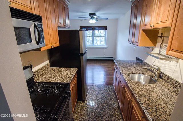 a kitchen with a sink stove and microwave