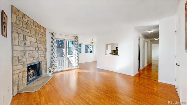 a view of empty room with wooden floor and fireplace