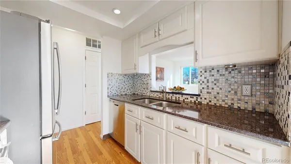 a kitchen with granite countertop a sink and a stove