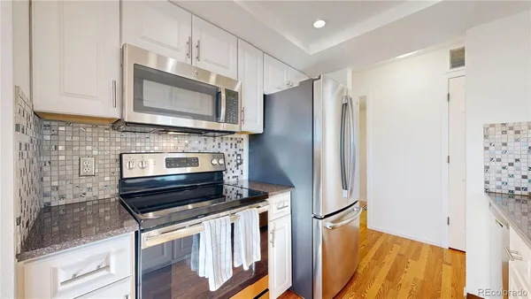 a kitchen with stainless steel appliances a refrigerator stove and microwave