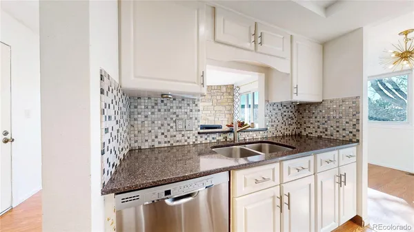 a kitchen with granite countertop a sink and a stove