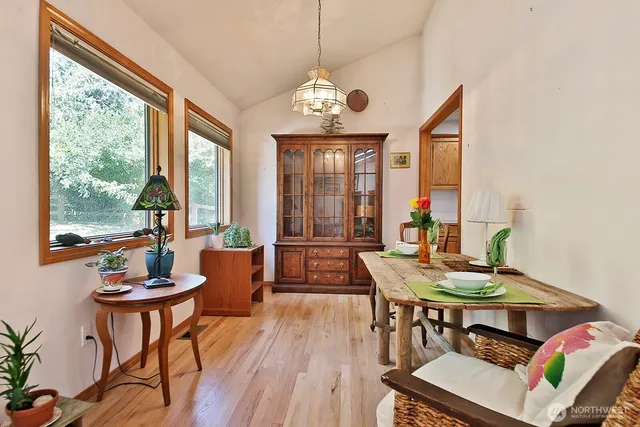 a view of a dining room with furniture window and wooden floor