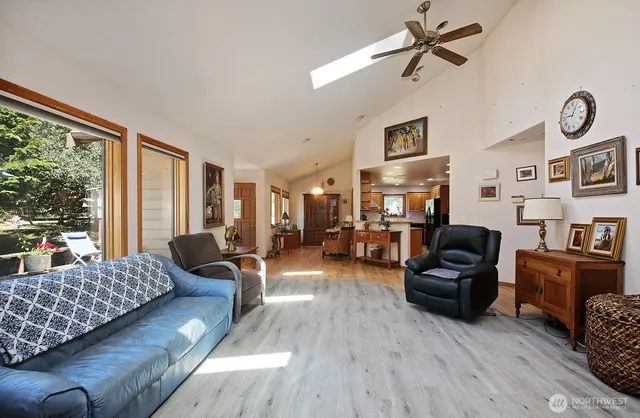 a kitchen with stainless steel appliances granite countertop a refrigerator a stove and a sink with wooden cabinets