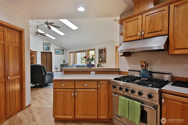 a kitchen with stainless steel appliances a sink cabinets and wooden floor