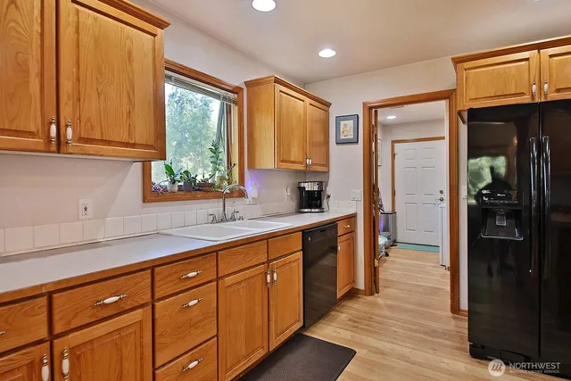 a bedroom with a bed and dresser with mirror