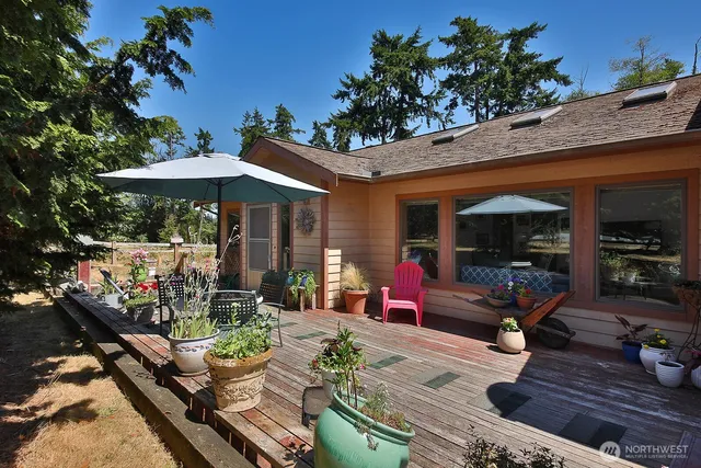 a front view of a house with potted plants