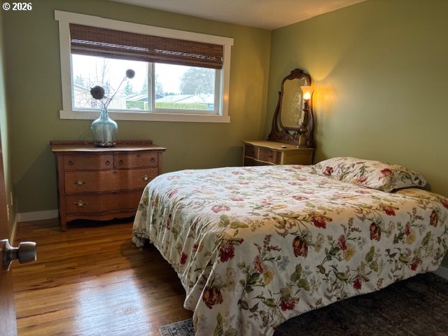 2130 Umpqua Road Woodburn, OR 97071 - Photo 8 of 21 a bedroom with a bed and wooden floor
