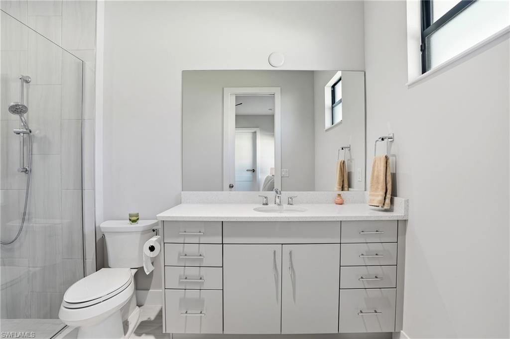 9177 Esplanade Boulevard Naples, FL 34119 - Photo 32 of 50 Bathroom featuring vanity and a stall shower