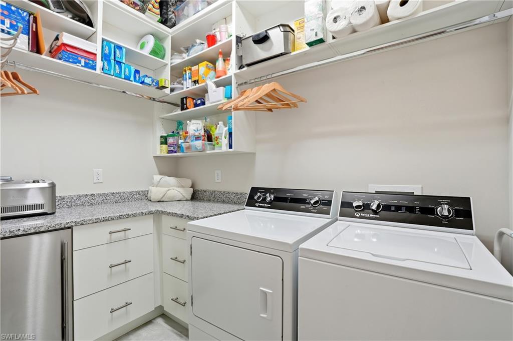 9177 Esplanade Boulevard Naples, FL 34119 - Photo 34 of 50 Laundry area featuring washing machine and clothes dryer