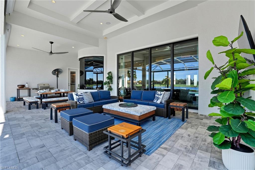9177 Esplanade Boulevard Naples, FL 34119 - Photo 39 of 50 View of patio / terrace with ceiling fan, an outdoor living space, and a water view