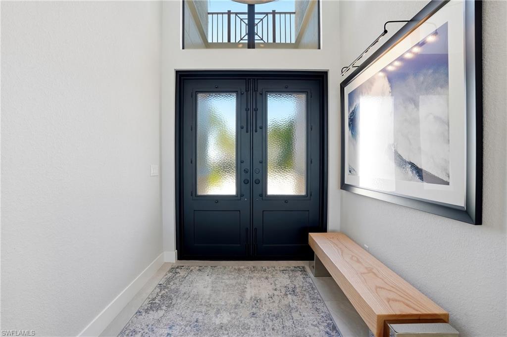 9177 Esplanade Boulevard Naples, FL 34119 - Photo 8 of 50 Entrance foyer with a textured wall and french doors