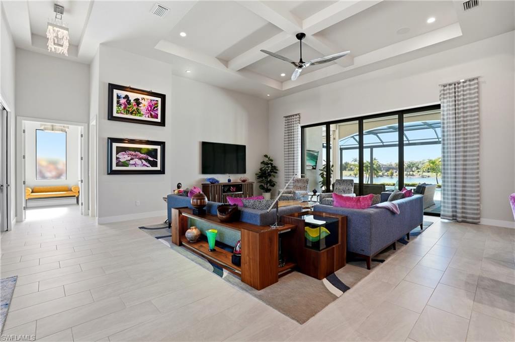 9177 Esplanade Boulevard Naples, FL 34119 - Photo 10 of 50 Living room featuring a high ceiling, coffered ceiling, beam ceiling, recessed lighting, and a ceiling fan