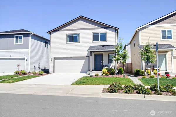 a front view of a house with a yard and garage