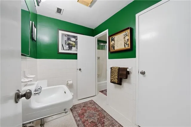 a bathroom with a sink mirror and window
