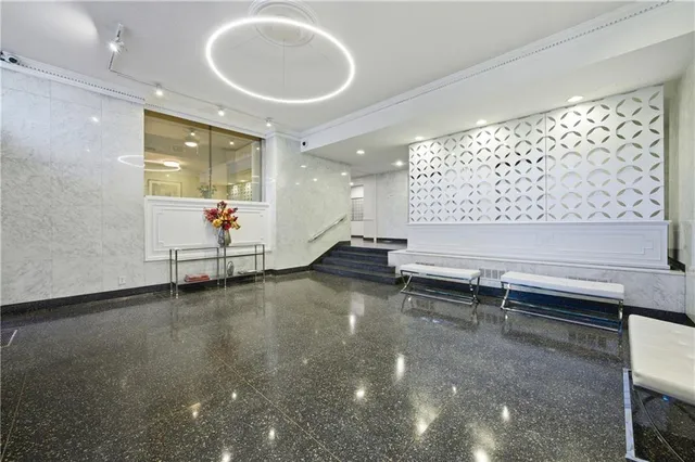 a view of a room with gym equipment and windows