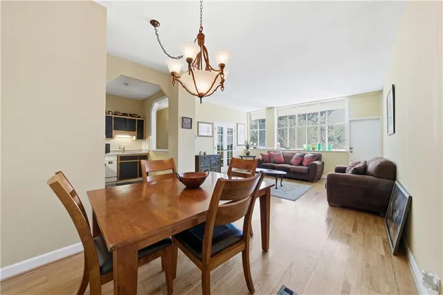 a living room with furniture a dining table and a chandelier