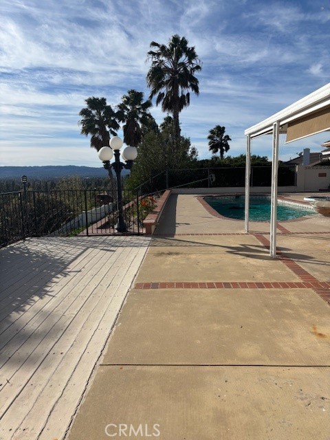 18772 Algiers Street Porter Ranch, CA 91326 - Photo 22 of 22 a vase of flowers sitting on a floor in front of a building