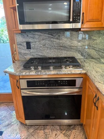 a stove top oven sitting inside of a kitchen