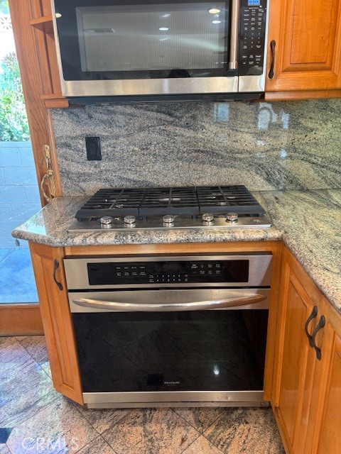 18772 Algiers Street Porter Ranch, CA 91326 - Photo 6 of 22 a stove top oven sitting inside of a kitchen