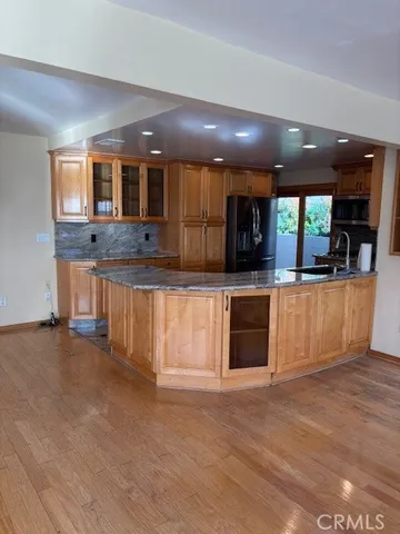 a large kitchen with stainless steel appliances granite countertop a large counter top and a stove