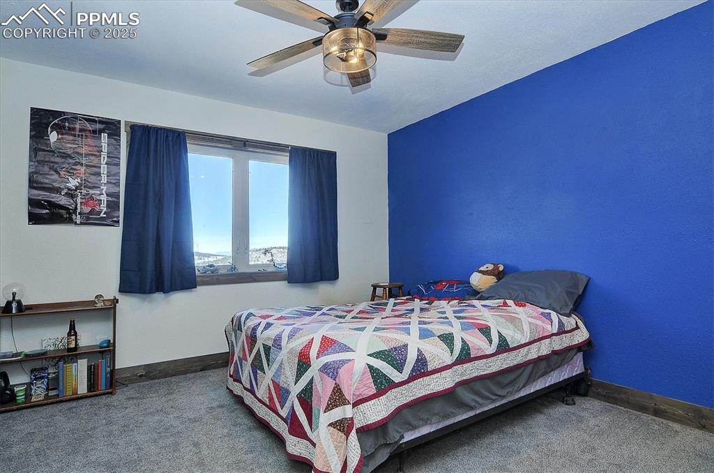 1115 Eagles Gate Road Westcliffe, CO 81252 - Photo 17 of 49 a bedroom with a bed and window