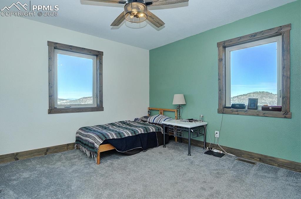 1115 Eagles Gate Road Westcliffe, CO 81252 - Photo 19 of 49 a bedroom with a bed and a window