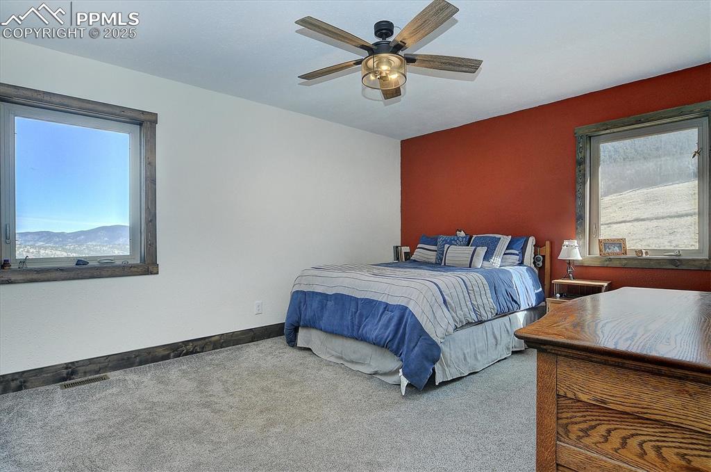 1115 Eagles Gate Road Westcliffe, CO 81252 - Photo 20 of 49 a spacious bedroom with a bed and window
