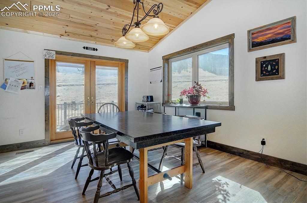 1115 Eagles Gate Road Westcliffe, CO 81252 - Photo 10 of 49 a view of a dining room with furniture window and wooden floor