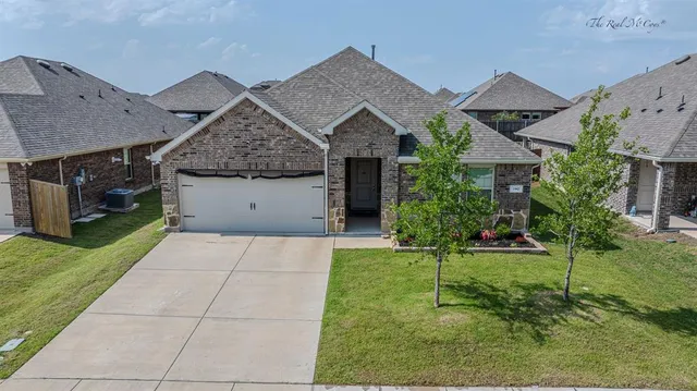 a front view of house with a garden
