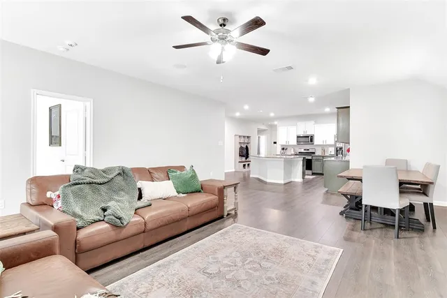 a living room with furniture and kitchen view