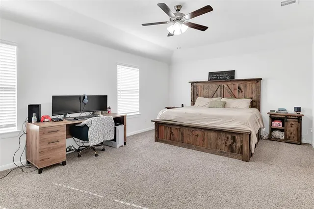 a bedroom with a bed and a couch