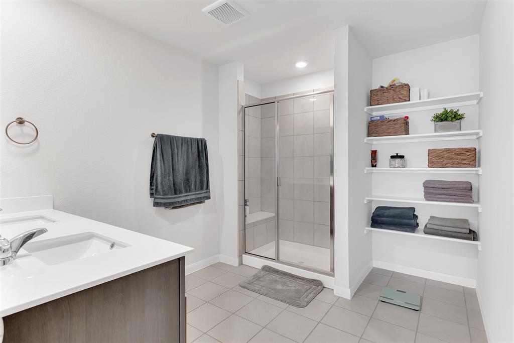 707 Range Drive Princeton, TX 75407 - Photo 16 of 29 a bathroom with a sink a toilet and shower