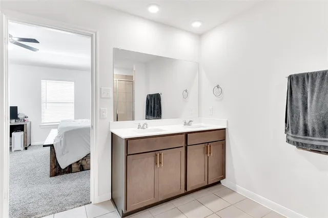 a spacious bathroom with a double vanity sink and a mirror