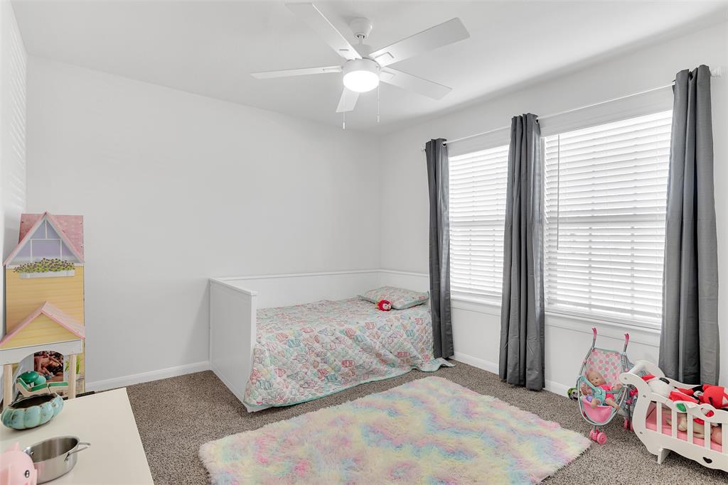 707 Range Drive Princeton, TX 75407 - Photo 19 of 29 a bedroom with a bed and a window