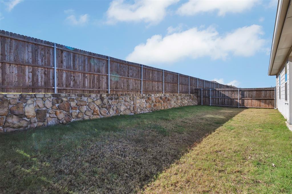 707 Range Drive Princeton, TX 75407 - Photo 25 of 29 a view of backyard with wooden fence