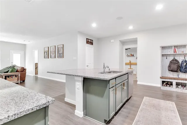 a kitchen with stainless steel appliances granite countertop a sink and cabinets