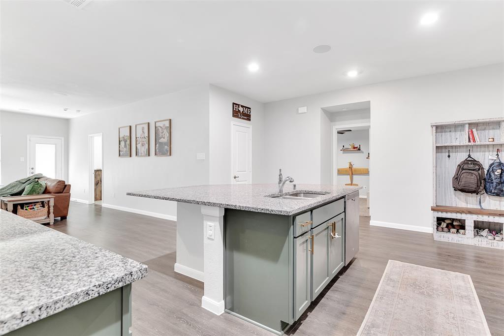 707 Range Drive Princeton, TX 75407 - Photo 6 of 29 a kitchen with stainless steel appliances granite countertop a sink and cabinets