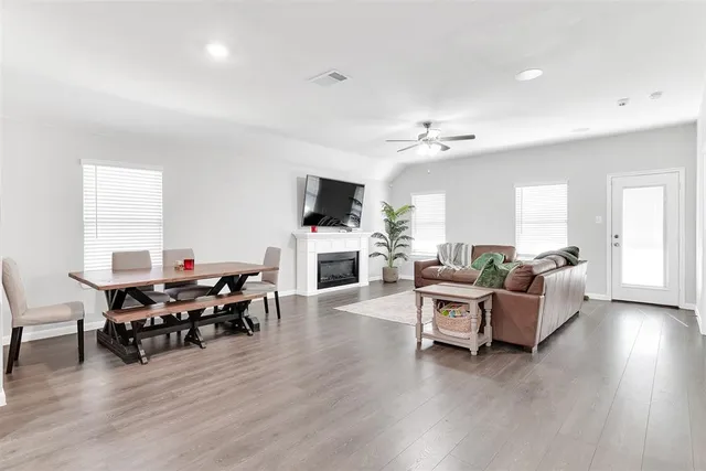 a living room with furniture a fireplace and a flat screen tv
