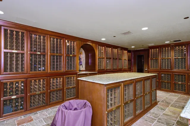 a kitchen with stainless steel appliances granite countertop a stove a sink and a large window