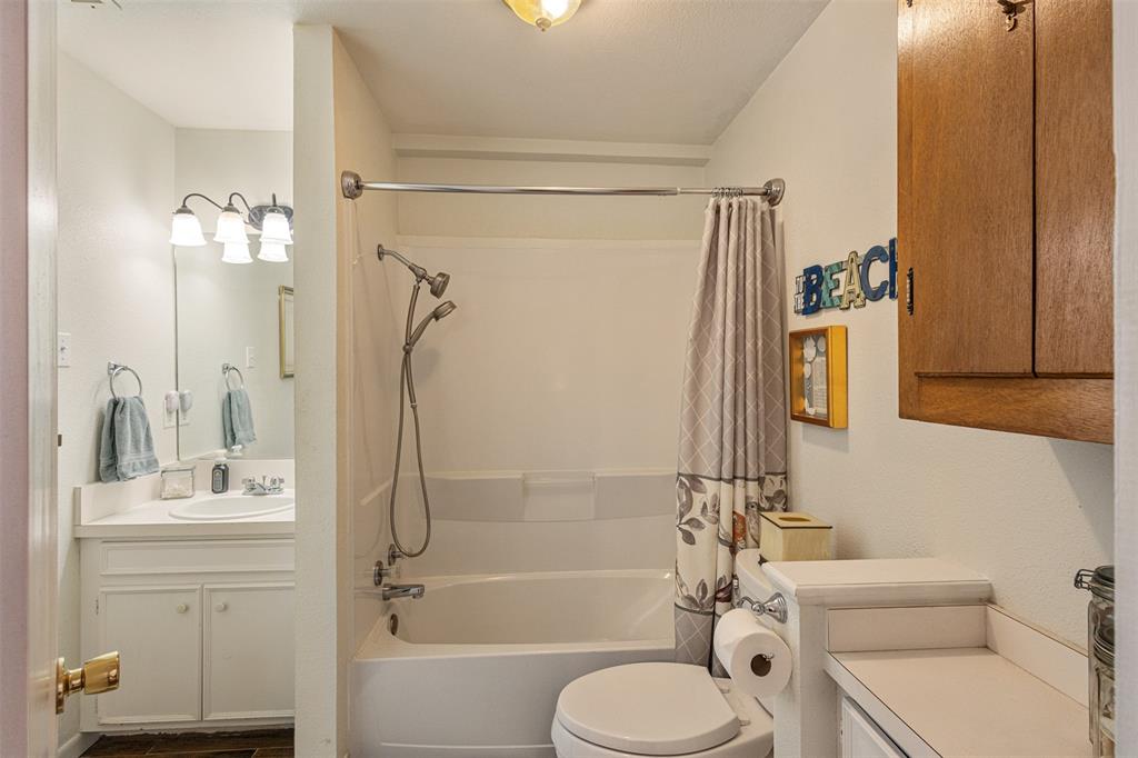 713 Midway Road Tool, TX 75143 - Photo 13 of 28 a bathroom with a sink toilet and shower