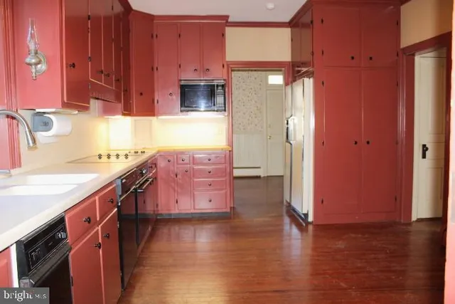 a kitchen with stainless steel appliances a sink and a refrigerator