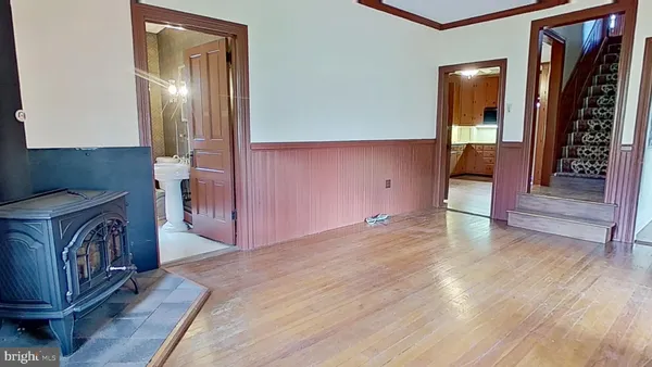 a view of a hallway with entryway wooden floor and front door