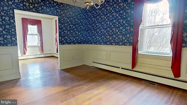 a view of an empty room and wooden floor