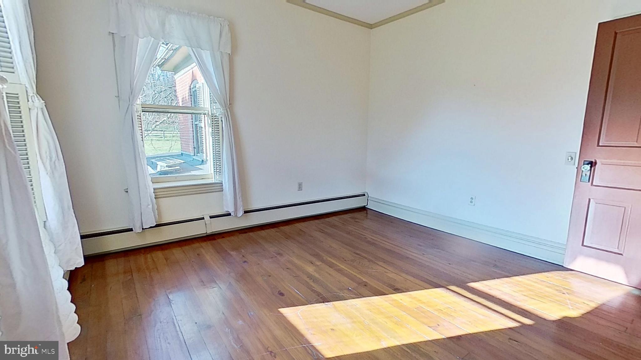 1447 Park Road Spring Grove, PA 17362 - Photo 8 of 13 an empty room with wooden floor and windows